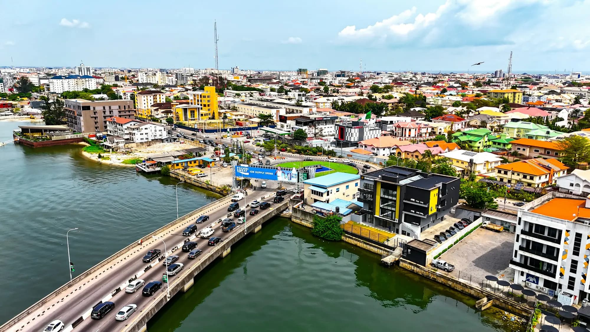 Aerial view of Lagos, with traffic crossing a bridge over the lagoon